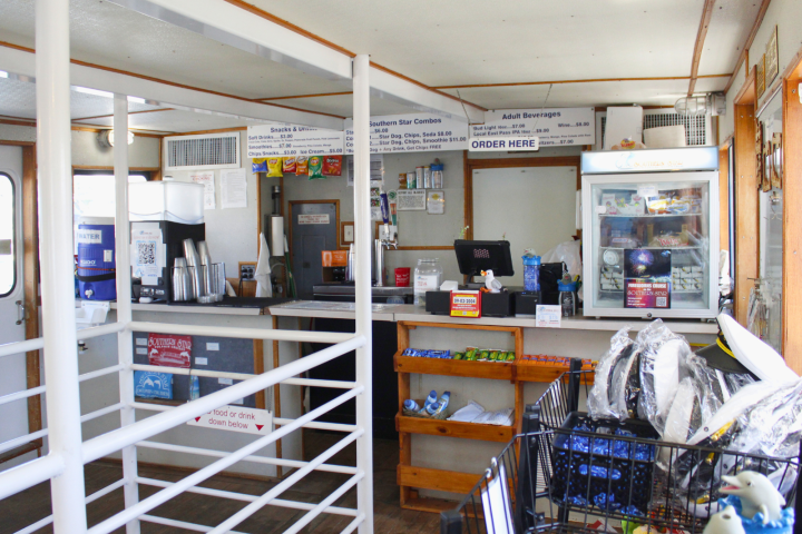 Snack bar with counter, menu, drinks, and snack items displayed.