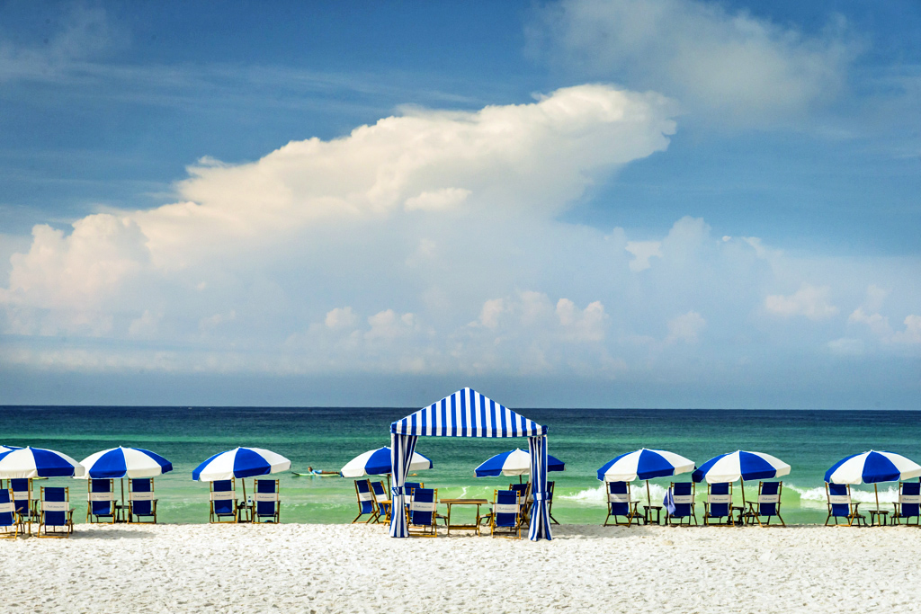 Cabanas on Beach an umbrella sitting on top of a sandy beach