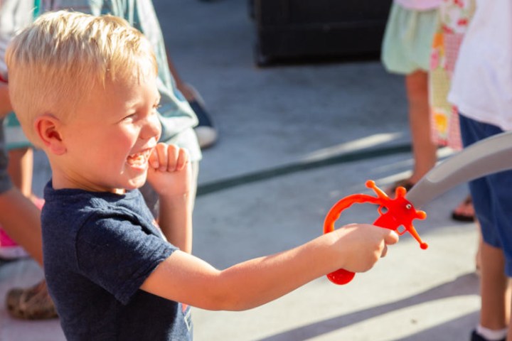 little boy aboard the Buccaneer Pirate Ship joining in the fun games