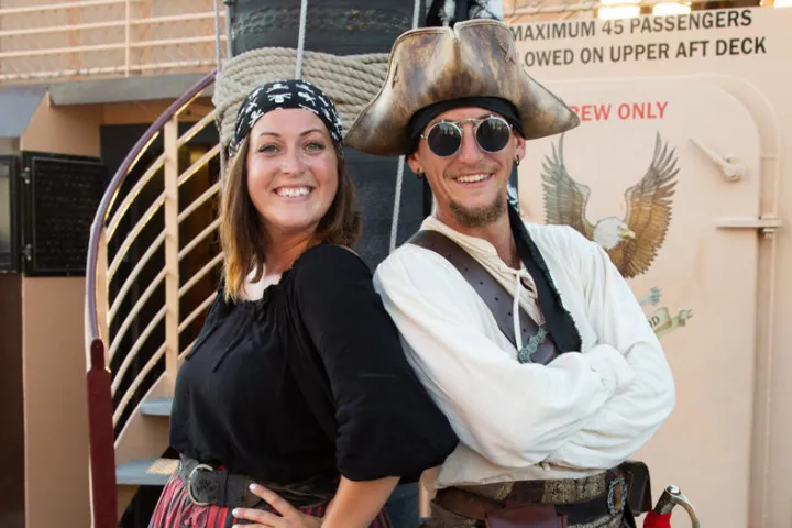 two people dressed as pirates on the pirate ship deck