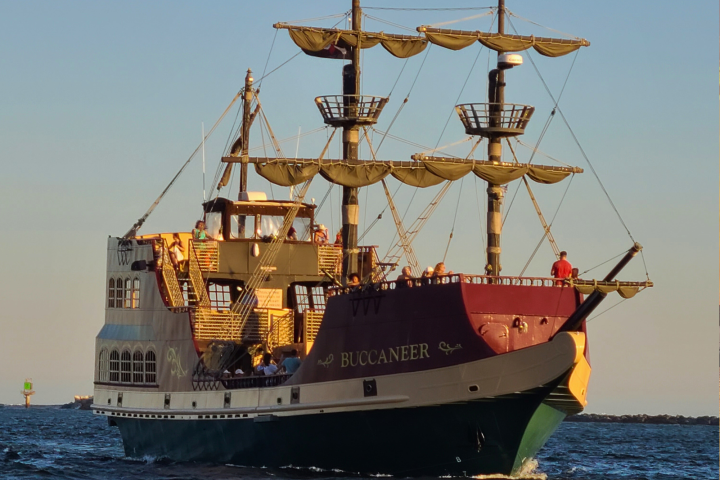 A pirate-themed ship named 'Buccaneer' sailing on the ocean.